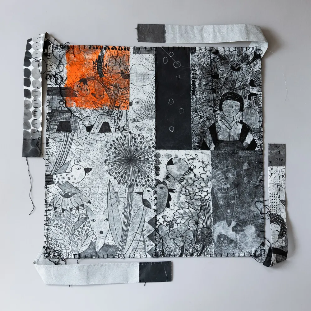 Hanji Bojagi #3, a square stitched hanji patchwork with a bright orange block at the upper left, black machine stitching and trailing thread, and paper straps on all four sides.