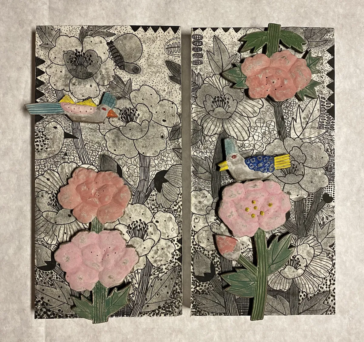 Talisman panel: pink ceramic peonies and birds set on a pair of drawn black-and-white panels